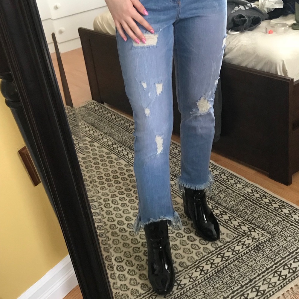 Blue distressed jeans with detailed hem
